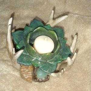 Handcrafted resin lotus flower nestled in antlers.